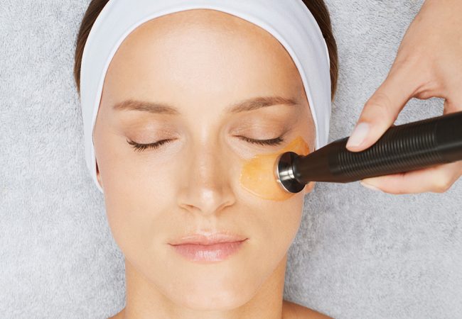 Woman's face getting facial treatment