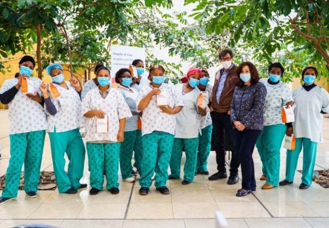 Dr Des and his sister with healthcare workers at a hospital
